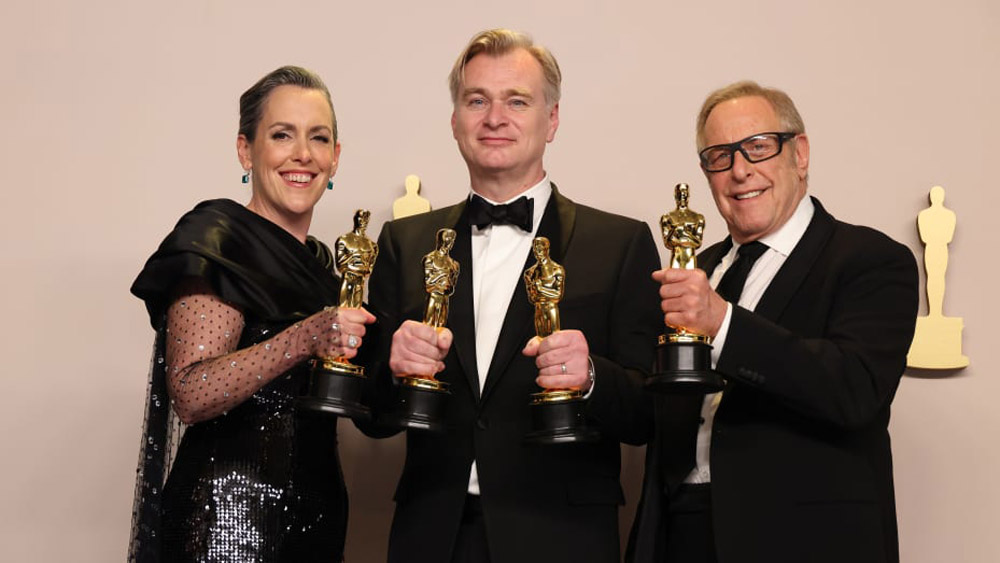 (L-R) Emma Thomas, Christopher Nolan and Charles Roven, winners of the Best Picture award for “Oppenheimer”, pose in the press room during the 96th Annual Academy Awards at Ovation Hollywood on March 10, 2024 in Hollywood, California.