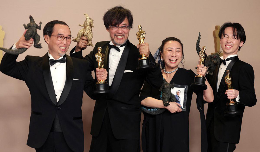 Takashi Yamazaki, Kiyoko Shibuya, Masaki Takahashi and Tatsuji Nojima pose with the Oscar for Best Visual Effects for Godzilla Minus One.
