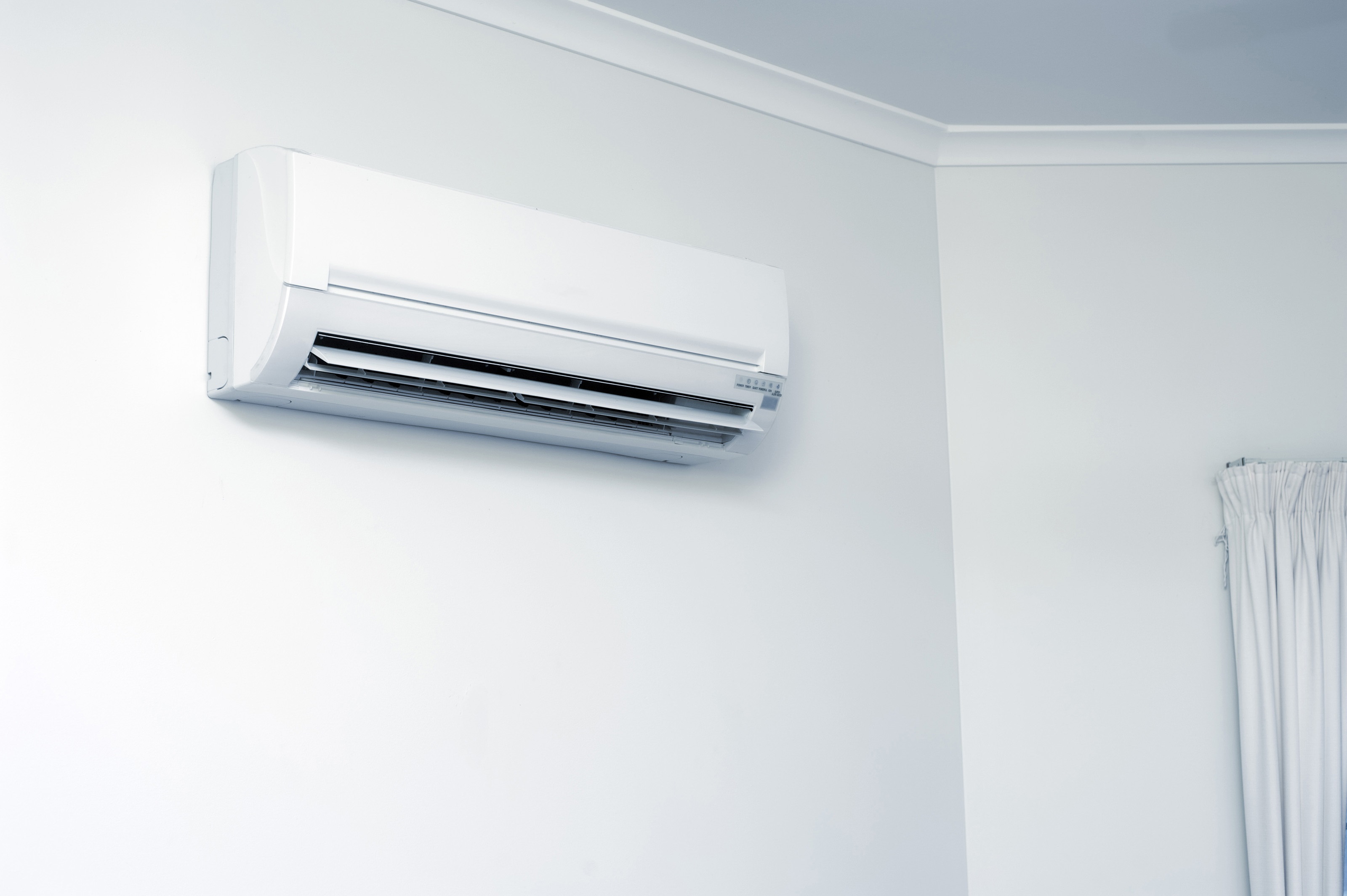 An air condition inside unit over a white wall