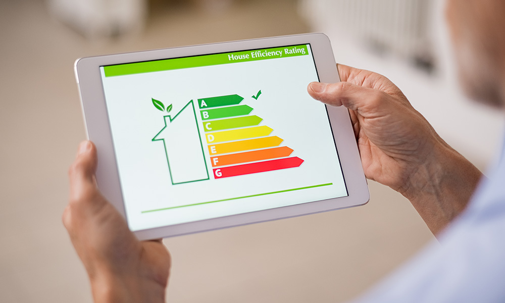 A tablet being held, showing the color-coded energy efficiency scale with a tick on A