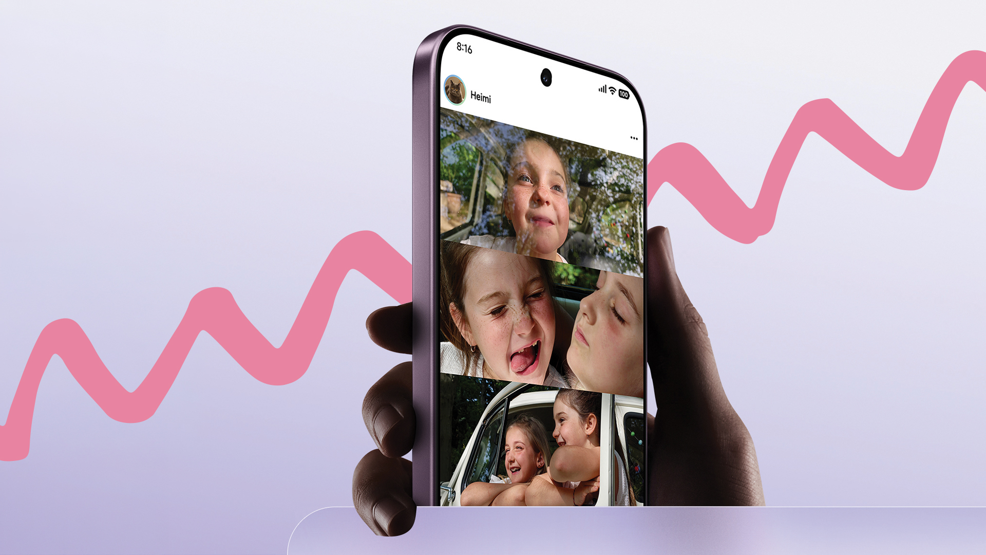 A hand holding a smartphone over a pink background. The phone shows photos of happy children in its screen. 
