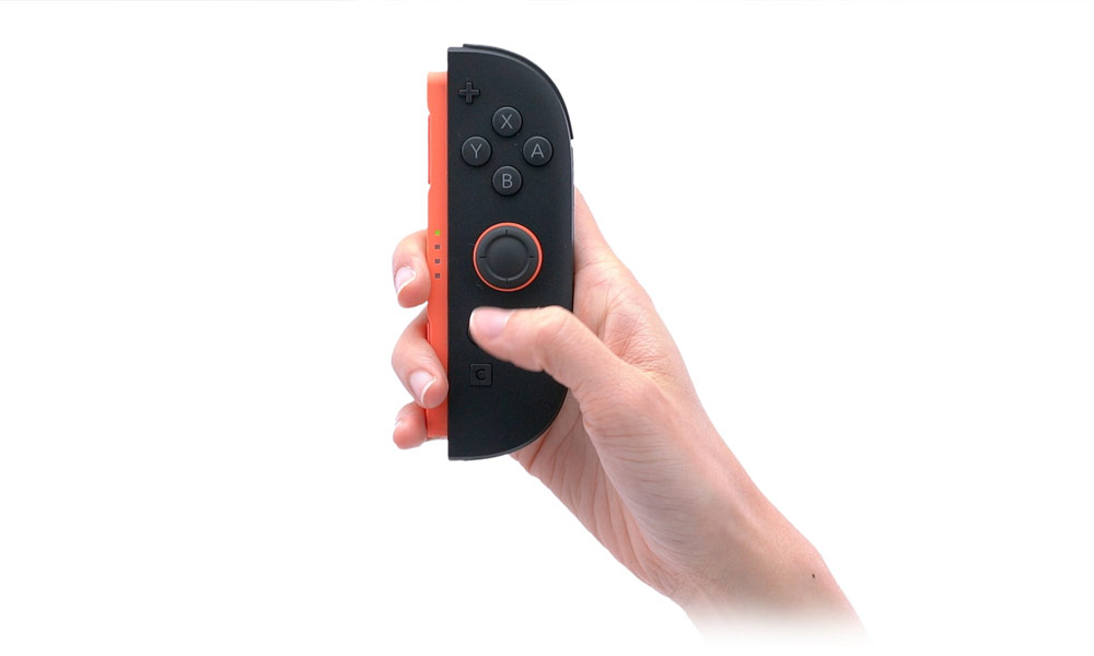 A hand grappling a Joy-Con 2