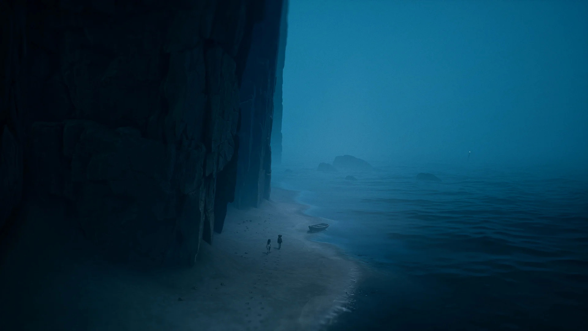 Scene from reanimal with the characters on a beach under a cliff