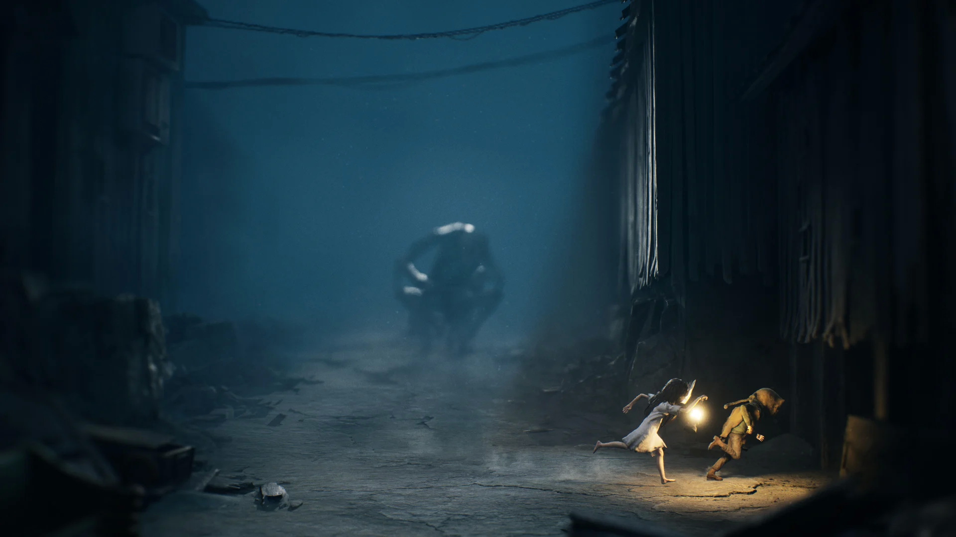 A scene from reanimal with the characters running from a looming monster