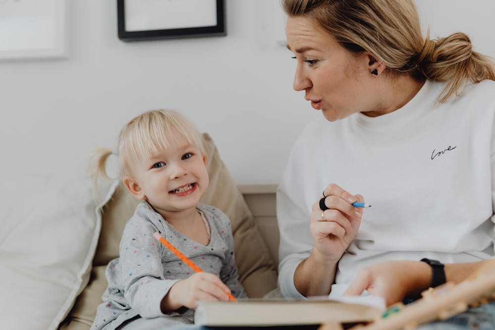 mom drawing with kid and having fun