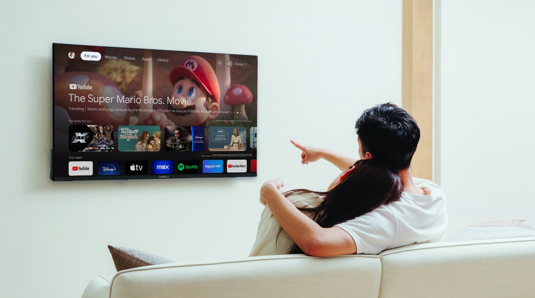 A couple where a man points at super mario on Turbo-X TV 