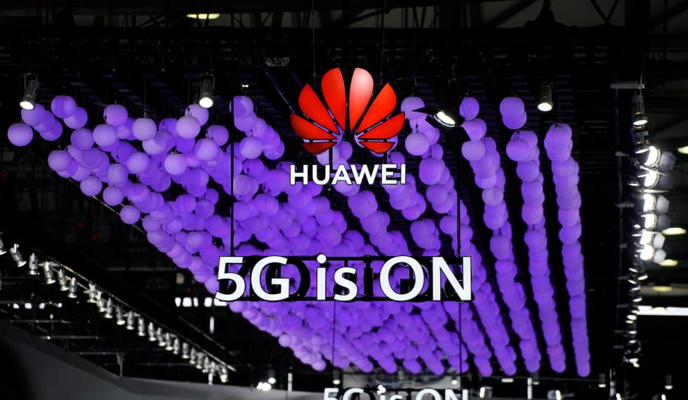 A Huawei logo and a 5G sign are pictured at Mobile World Congress (MWC) in Shanghai