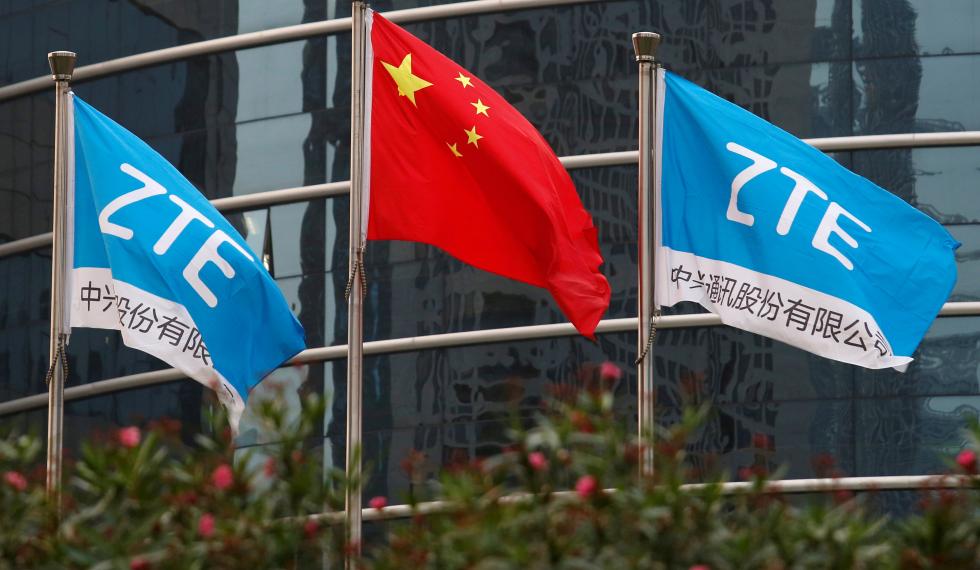 FILE PHOTO: A Chinese national flag and two flags bearing the name of ZTE fly outside the ZTE R&amp;D building in Shenzhen, China