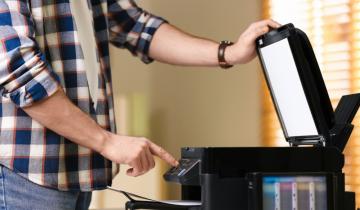 man using modern multifunction printer office