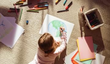 kid drawing lying on the ground