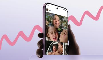 A hand holding a smartphone over a pink background. The phone shows photos of happy children in its screen. 